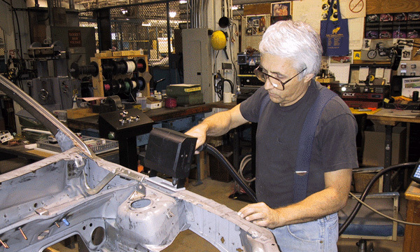 Pin marking car frame with a handheld dot peen pin marker